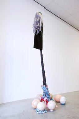 Dolly and her silicones – 2021 -stoneware, glaze, textile, shoes, artificial hair, artificial clay, wood – 230x74x65 cm